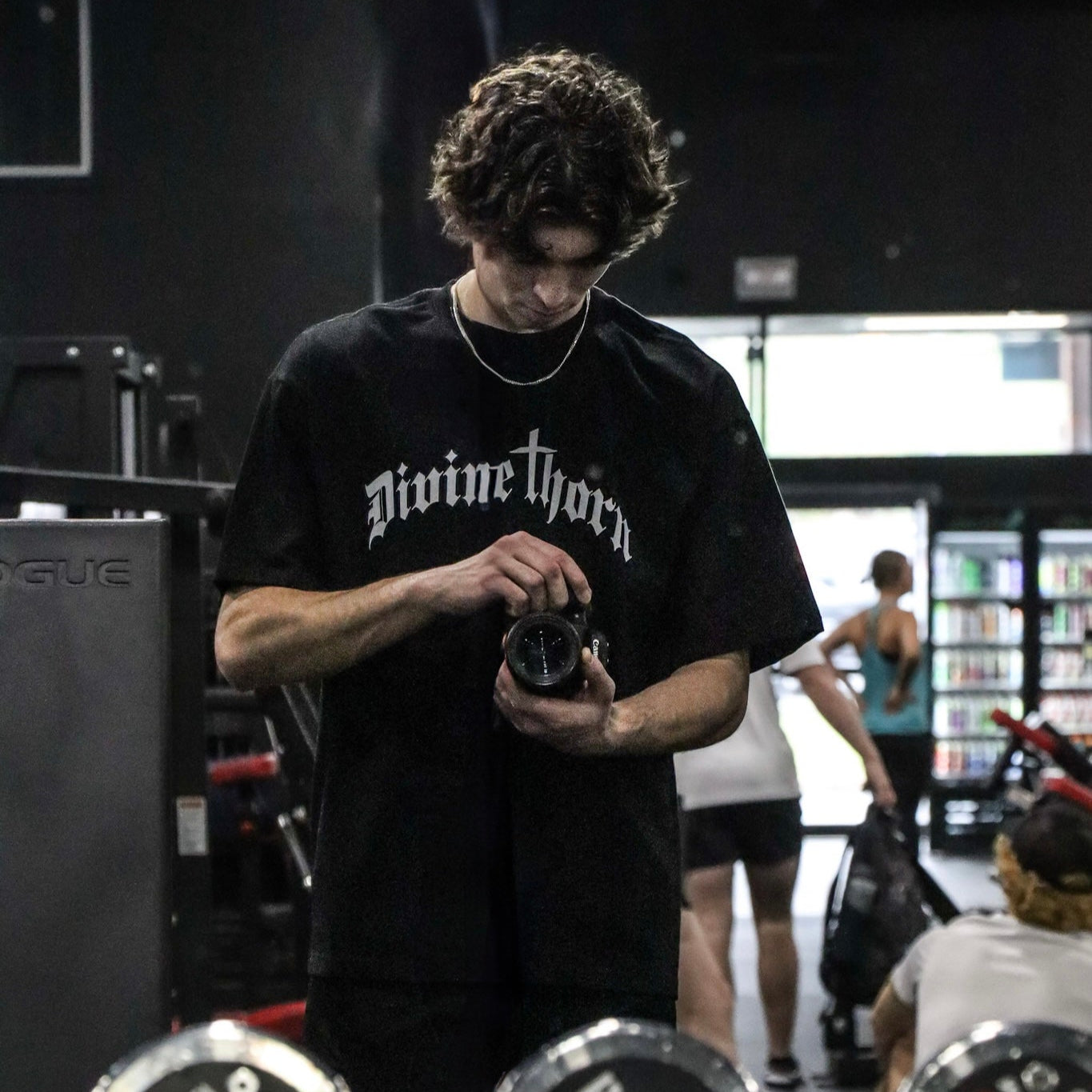 Person in a gym setting with weights and equipment around